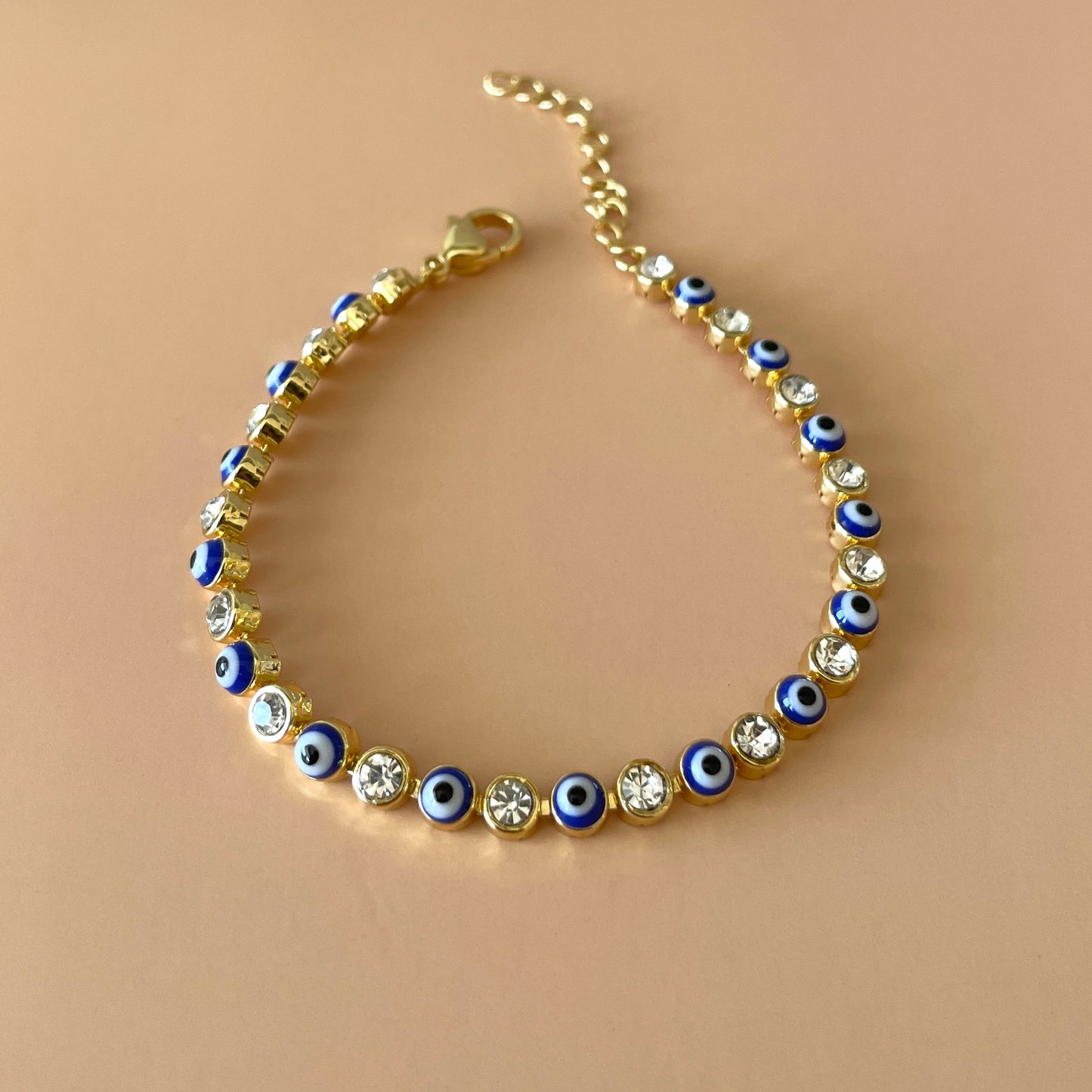 PULSERA TENNIS GOLD OJO AZUL